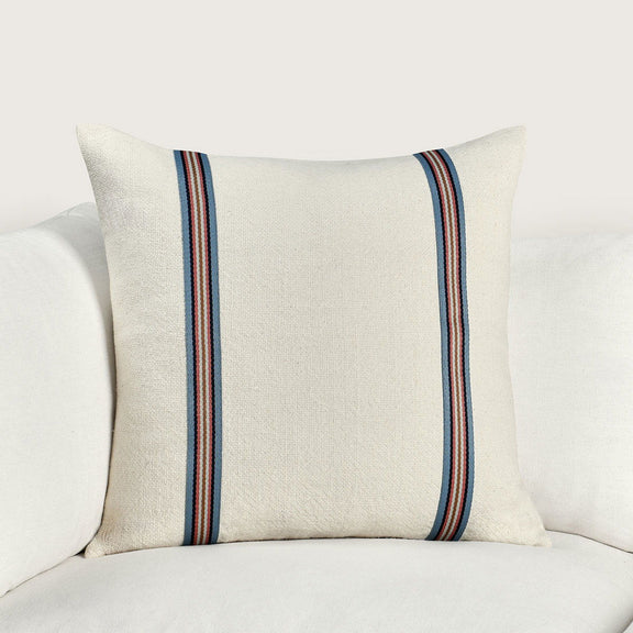 Ivory square pillow with navy, red, and tan stripe band on front