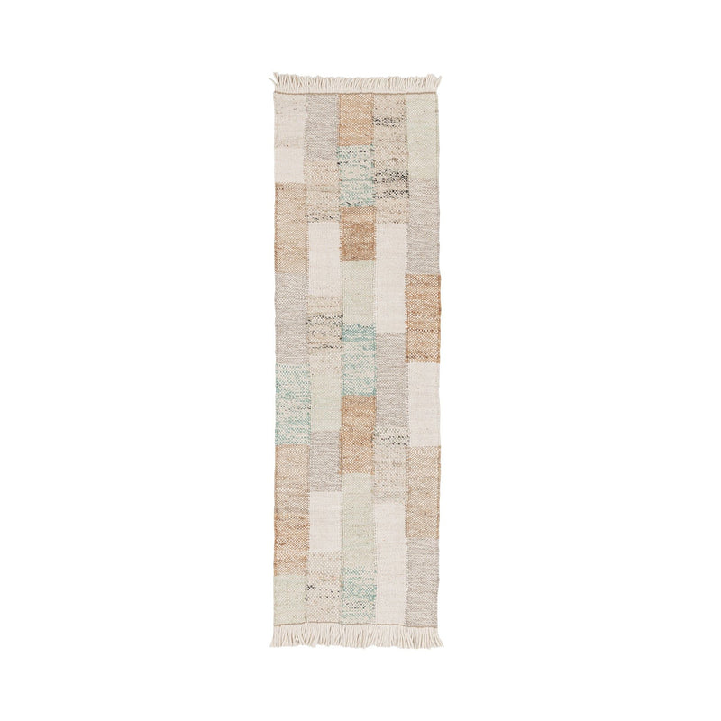 Ritsa rug with vertical patchwork blocks in beige, cream, gray, and muted blue; fringes