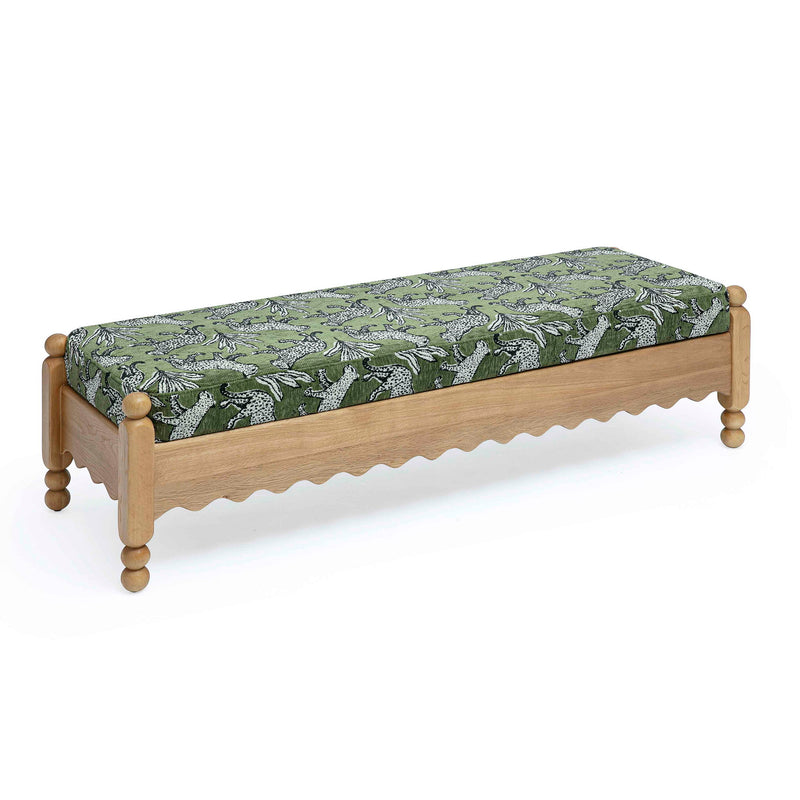 Green leopard jacquard upholstered bench with scalloped front and turned wooden legs