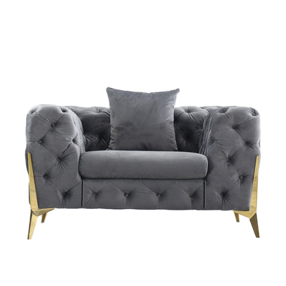 Dark gray diamond-tufted accent chair with matching throw pillow and gold legs