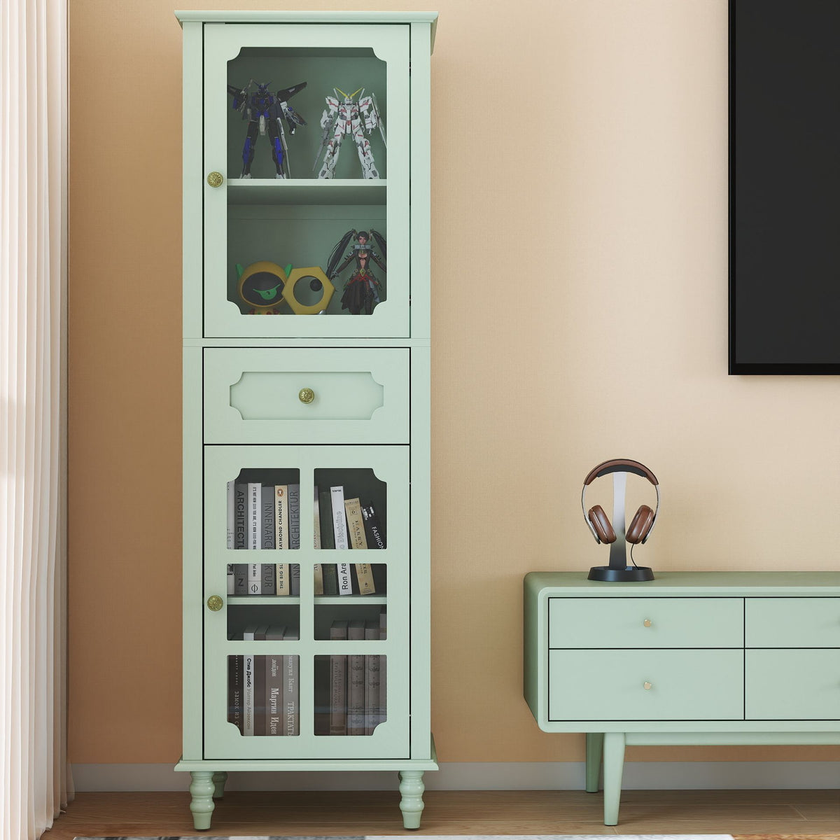 Green display cabinet with glass doors, a drawer, adjustable shelves and decorative brass knobs
