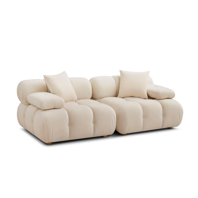 Modular loveseat sofa in white upholstery with padded seat cushions and matching throw pillows