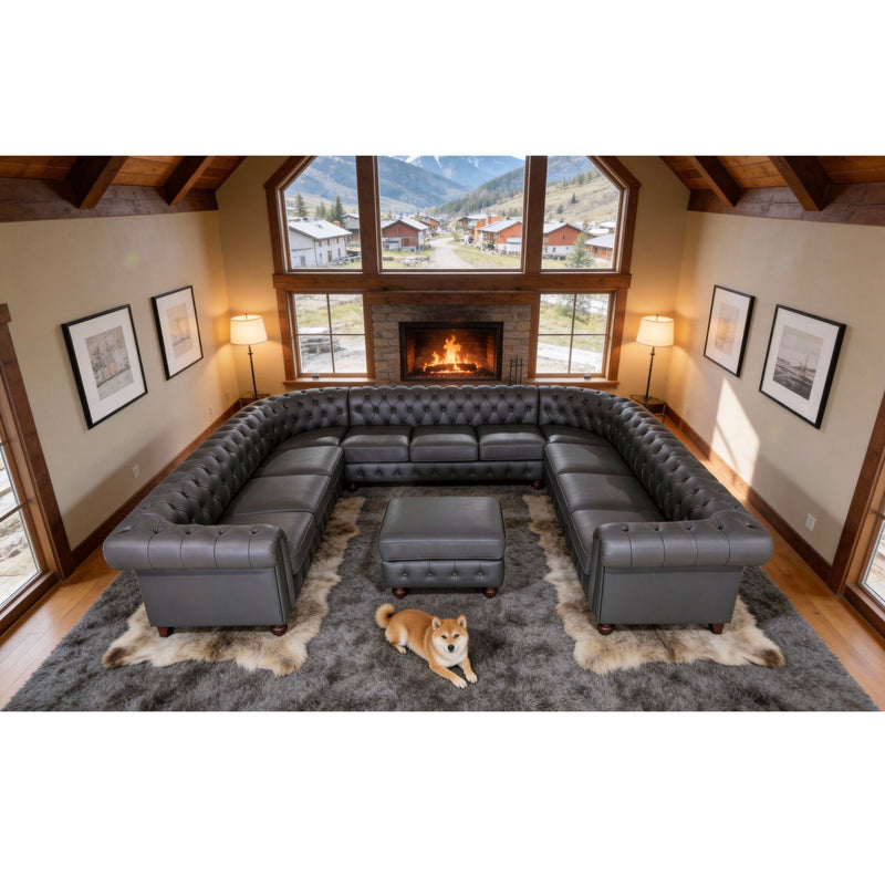 Dark gray tufted U-shape sectional sofa with central ottoman and rolled arm sections