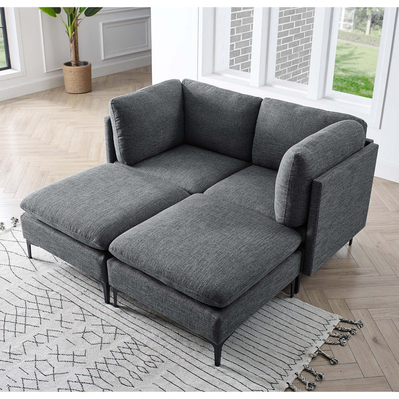 Dark gray modular sectional sofa with tall legs and chaise ottoman, upholstered cushions
