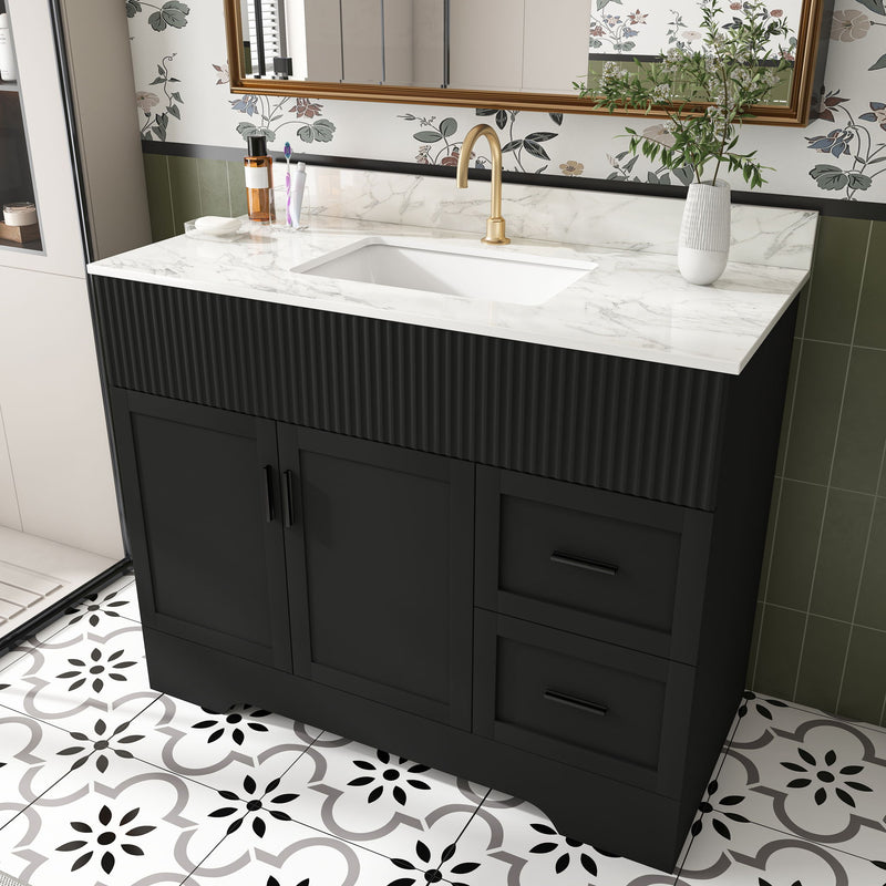 Black bathroom vanity with fluted cabinet, center sink, and soft-close doors and drawers