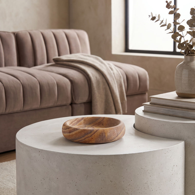 Round sandstone tray on a white pedestal, with marbled sand and brown pattern