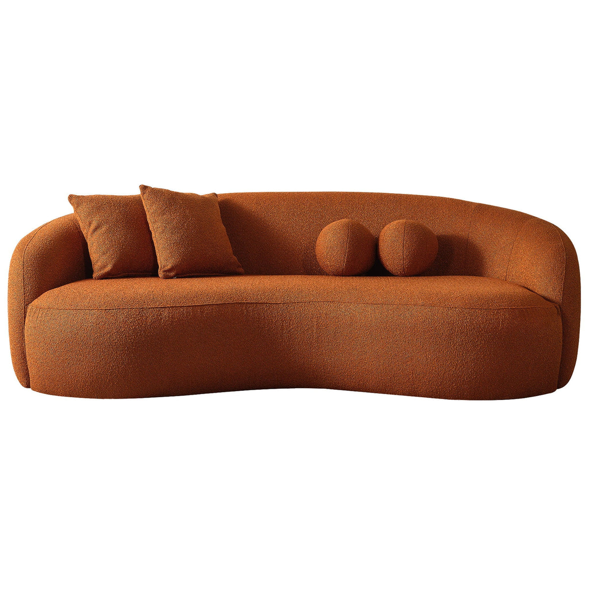 Curvy boucle sofa in burnt orange-brown with two back cushions and round accent pillows
