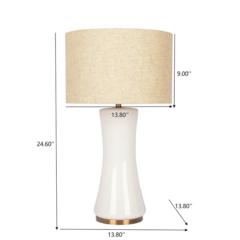 White ceramic table lamp with beige drum shade and gold bottom accent