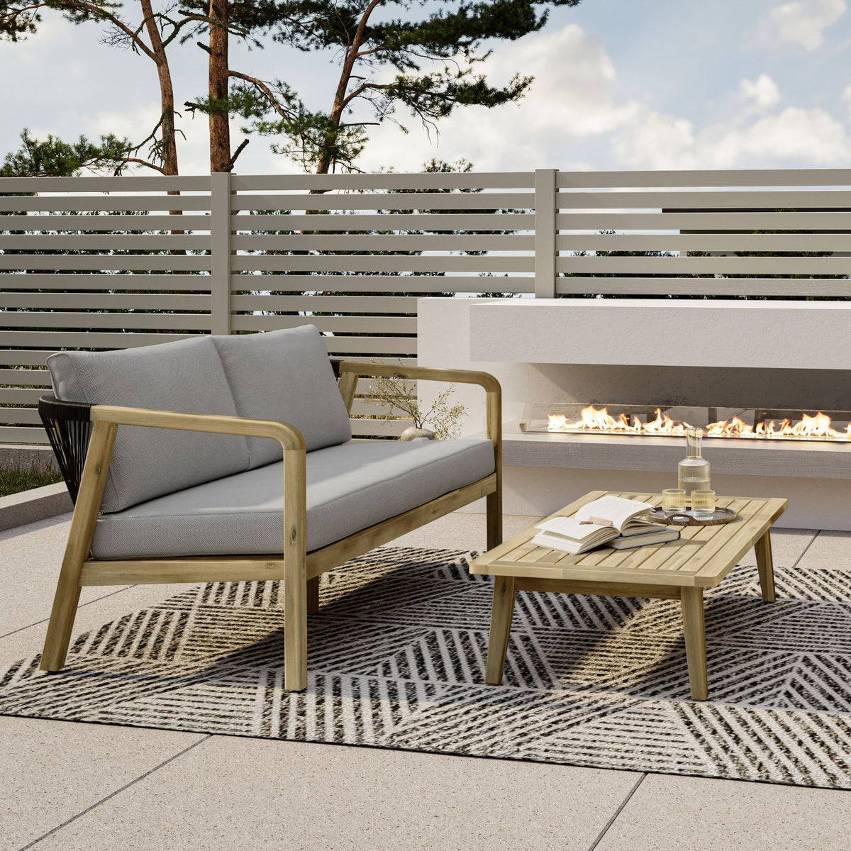 Outdoor patio sofa with stone gray cushions and light wood frame with arms
