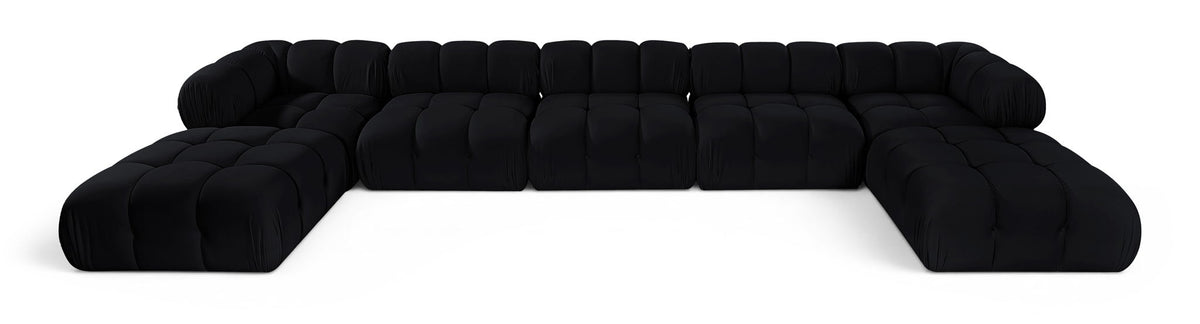 Black modular sectional sofa with tufted cushions and rounded armrests, curved layout