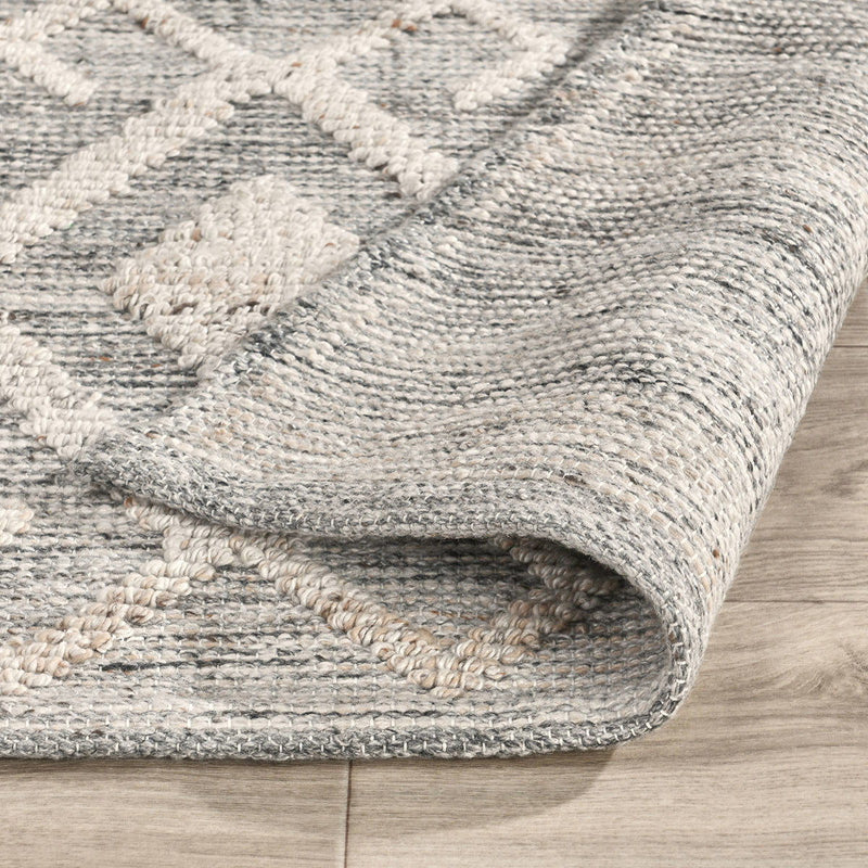 Tundra gray rug corner close-up with textured border and woven edge