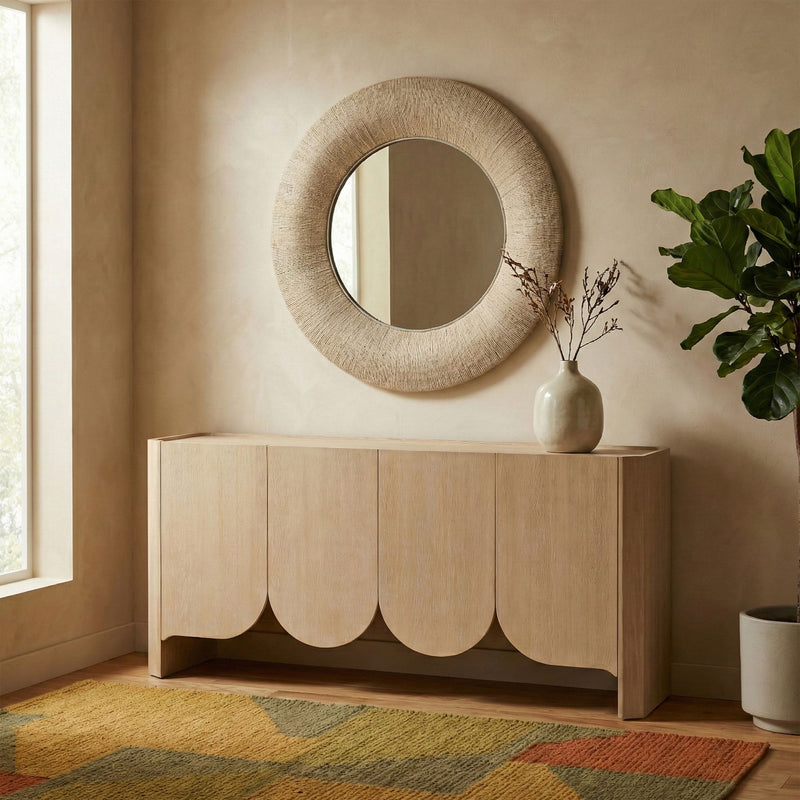 Round jute rope framed mirror on wall, light brown textured rope border, full oval view