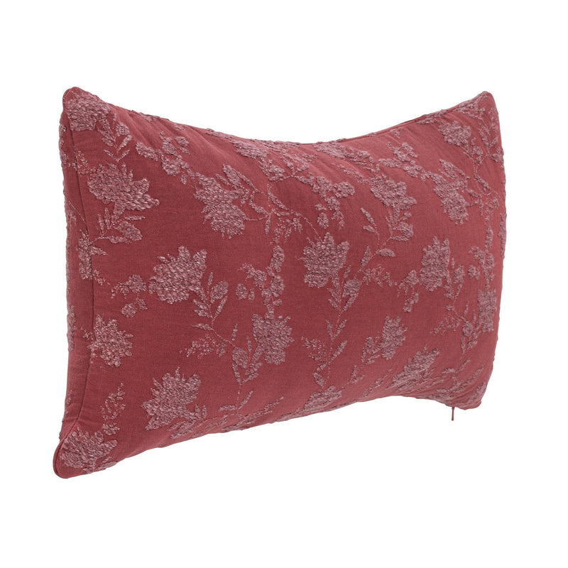 Burgundy red pillow with light floral vine pattern, angled view showing corner seams.