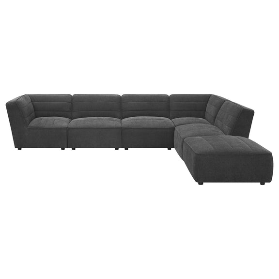 Charcoal modular sectional with box cushions, tufted back, and chaise ottoman extension