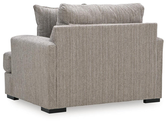 Gray chair and a half with textured fabric, rolled back, and black legs