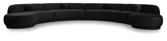 Black velvet sectional sofa with curved seat and padded arms