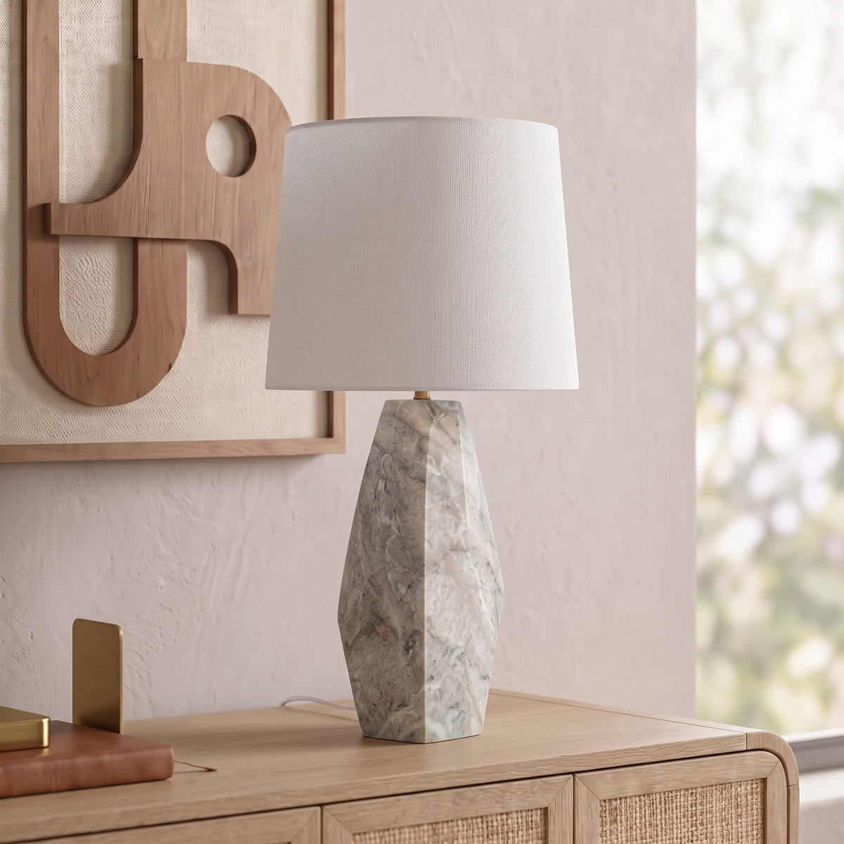 Marble table lamp with white fabric shade and gray faceted stone base