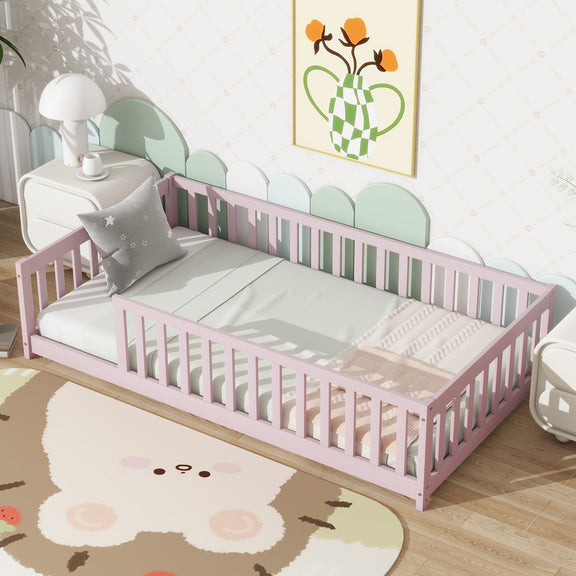 Pink twin floor bed with safety guardrails and fenced headboard, white mattress and gray pillow