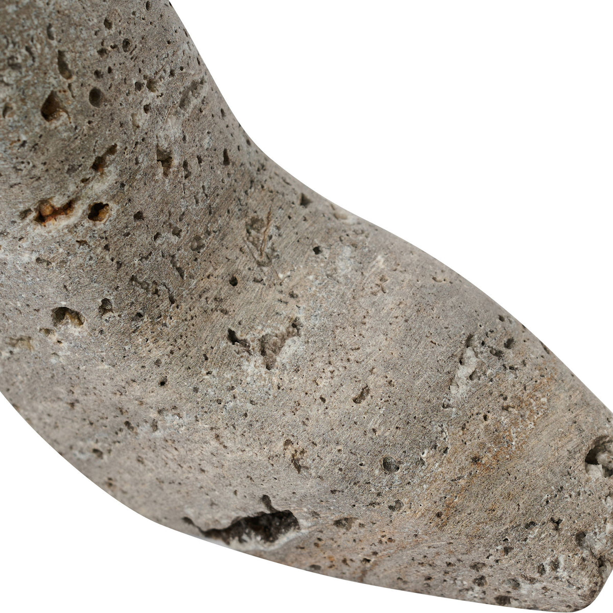 Gray travertine-style high-heel shoe sculpture close-up, speckled stone texture
