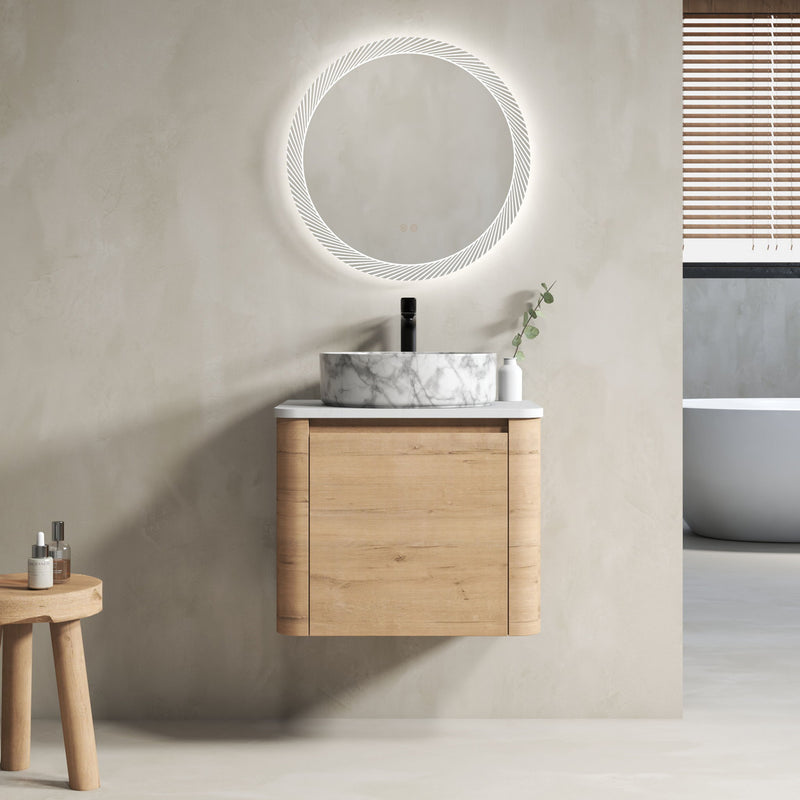 Wall-mounted bathroom vanity with white marble-look vessel sink, light wood cabinet, faucet