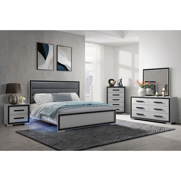 Gray upholstered bed with paneled headboard and footboard, styled bedding set