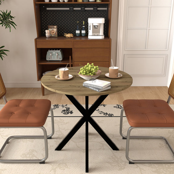 Round dining table with rustic wood top and black cross metal legs in room setting