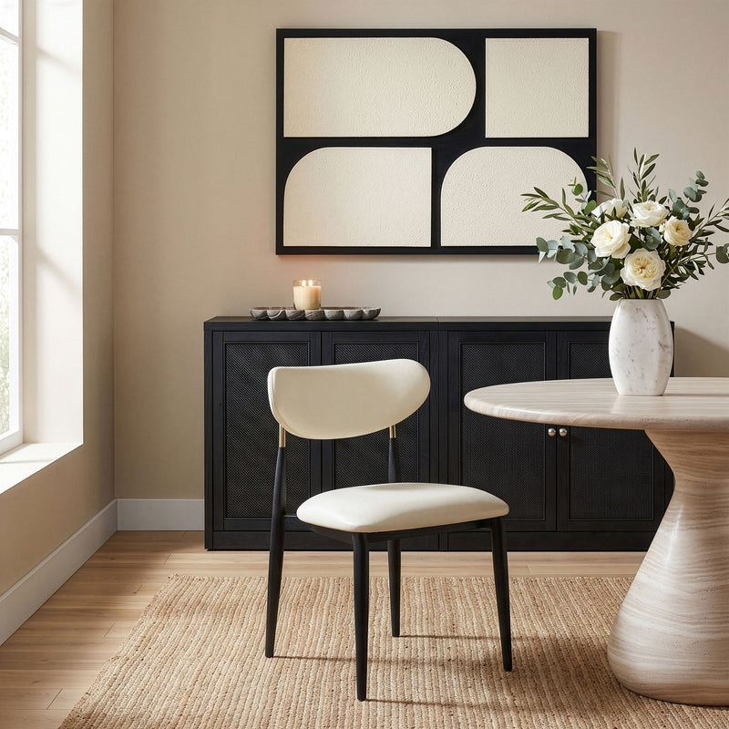 Cream vegan leather dining side chair, front view with padded seat and rounded back, black legs