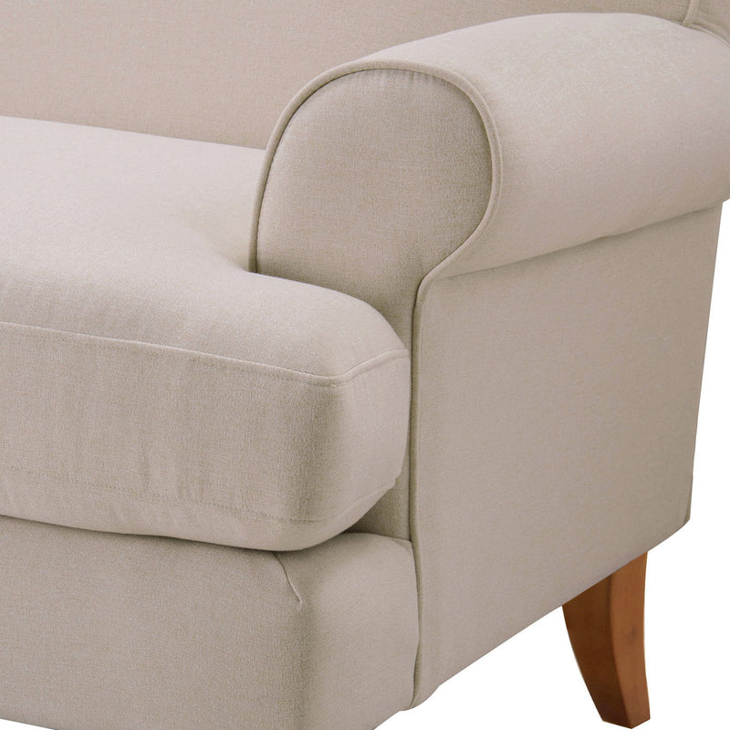 Light beige sofa arm and seat with curved piping detail and square cushion edges.