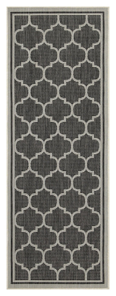 Dark charcoal polypropylene area rug with repeating quatrefoil pattern and thin border