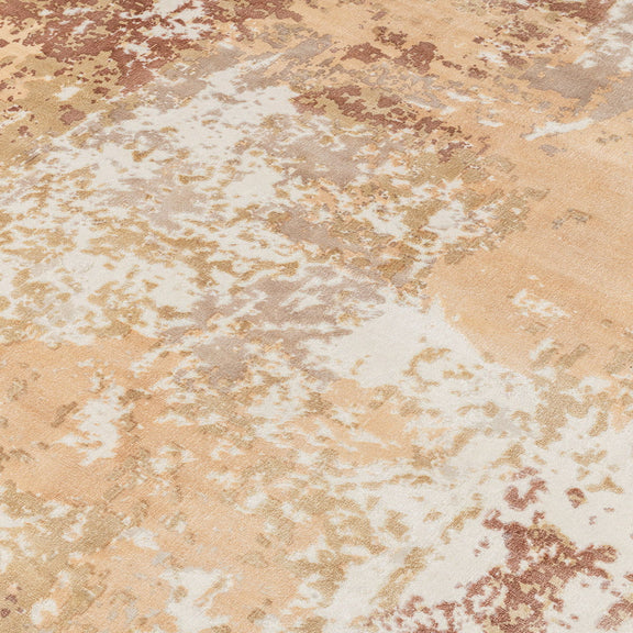 Beige area rug with distressed abstract pattern and subtle tan and rust tones.