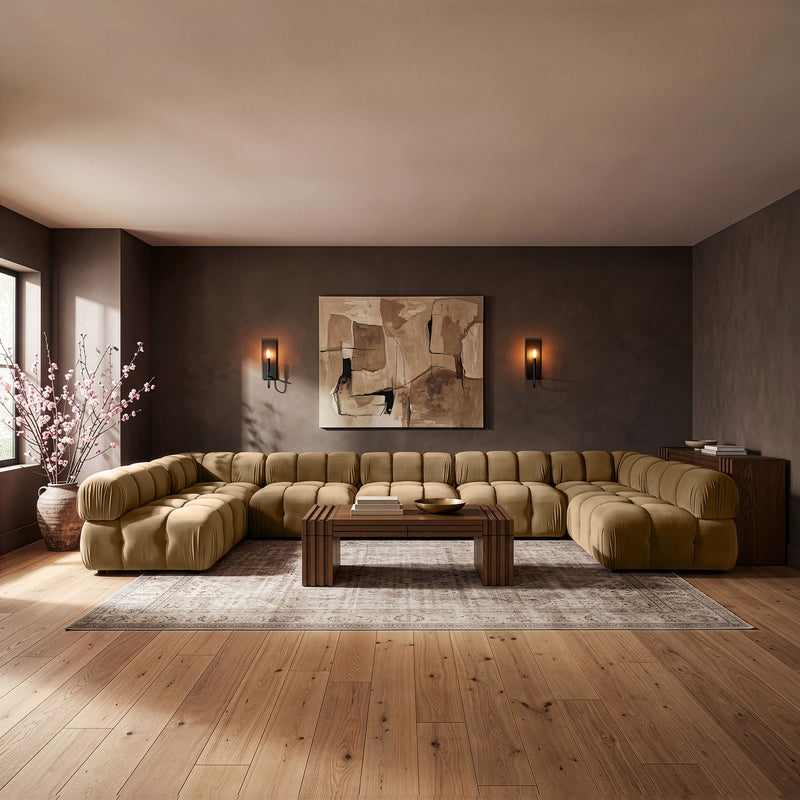 Light brown modular U-shaped sectional sofa with tufted cushions and corner chaise sections