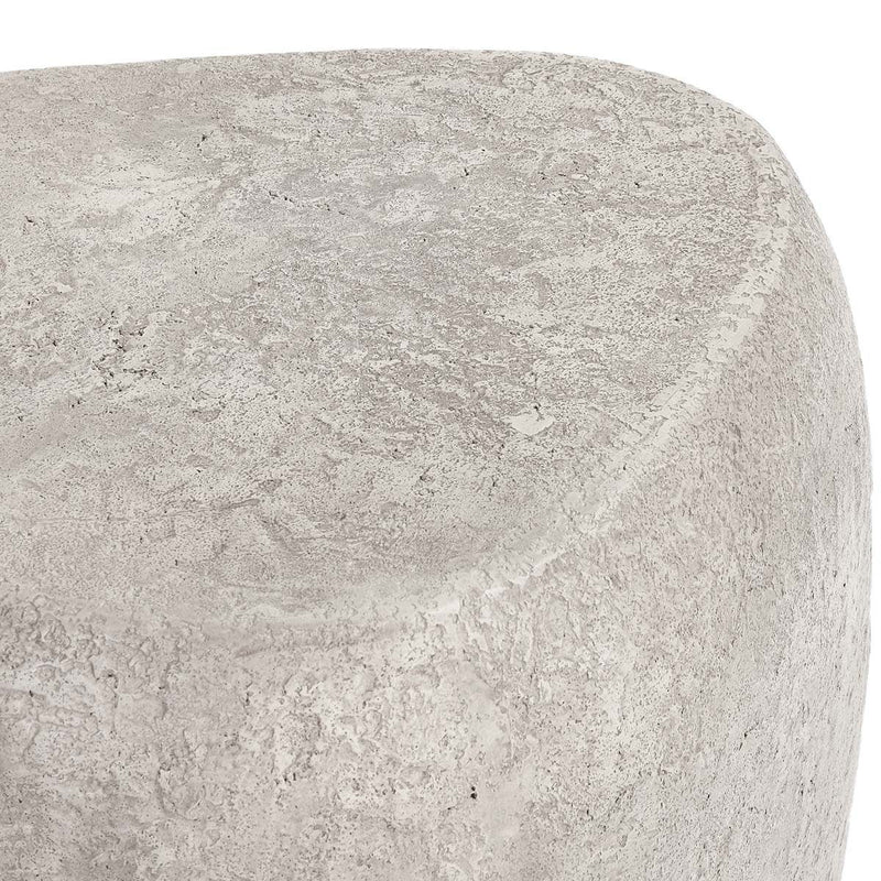 Light gray end table close-up showing speckled concrete finish and curved surface