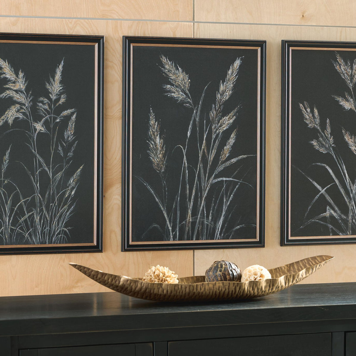 Three framed botanical leaf prints, dark background with pale feathery stems