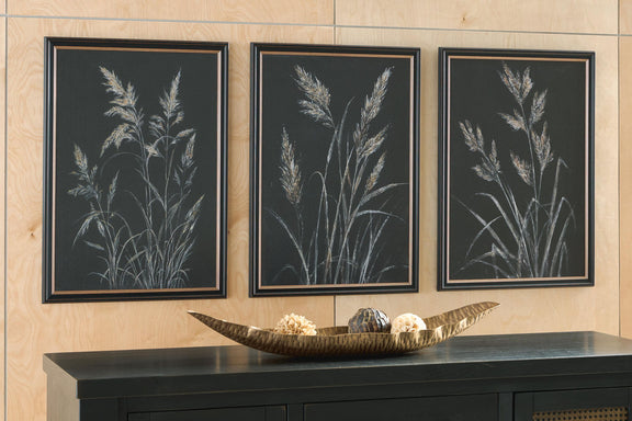 Three framed botanical leaf prints, dark background with pale feathery stems