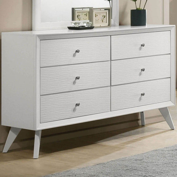 White dresser with mirror and six drawers, angled legs and round knob pulls.