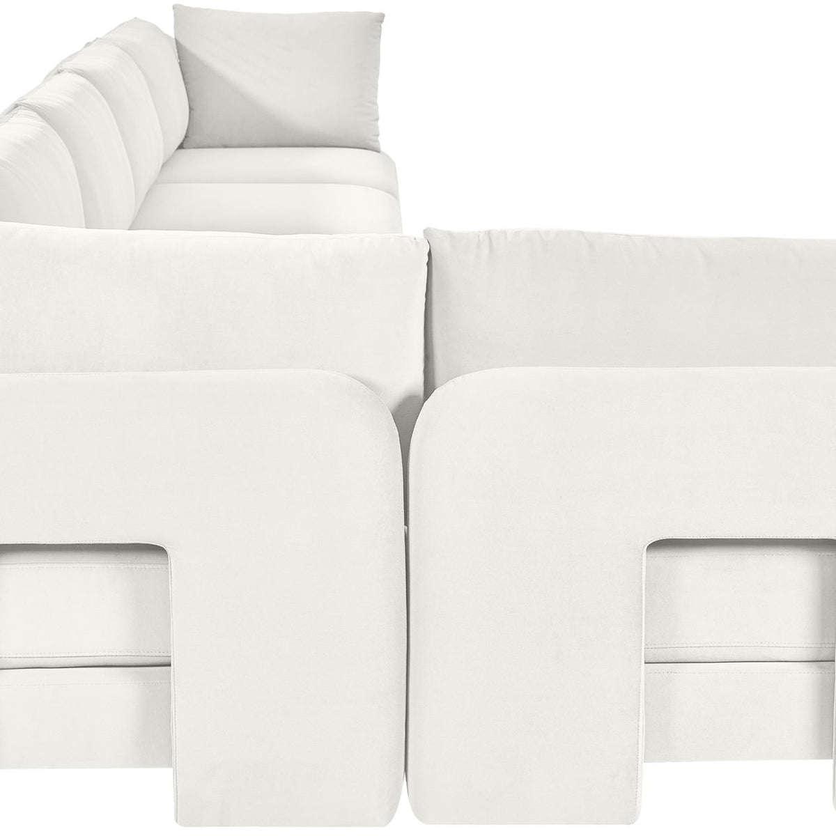 White armless sectional sofa with square panel accents and layered back cushions