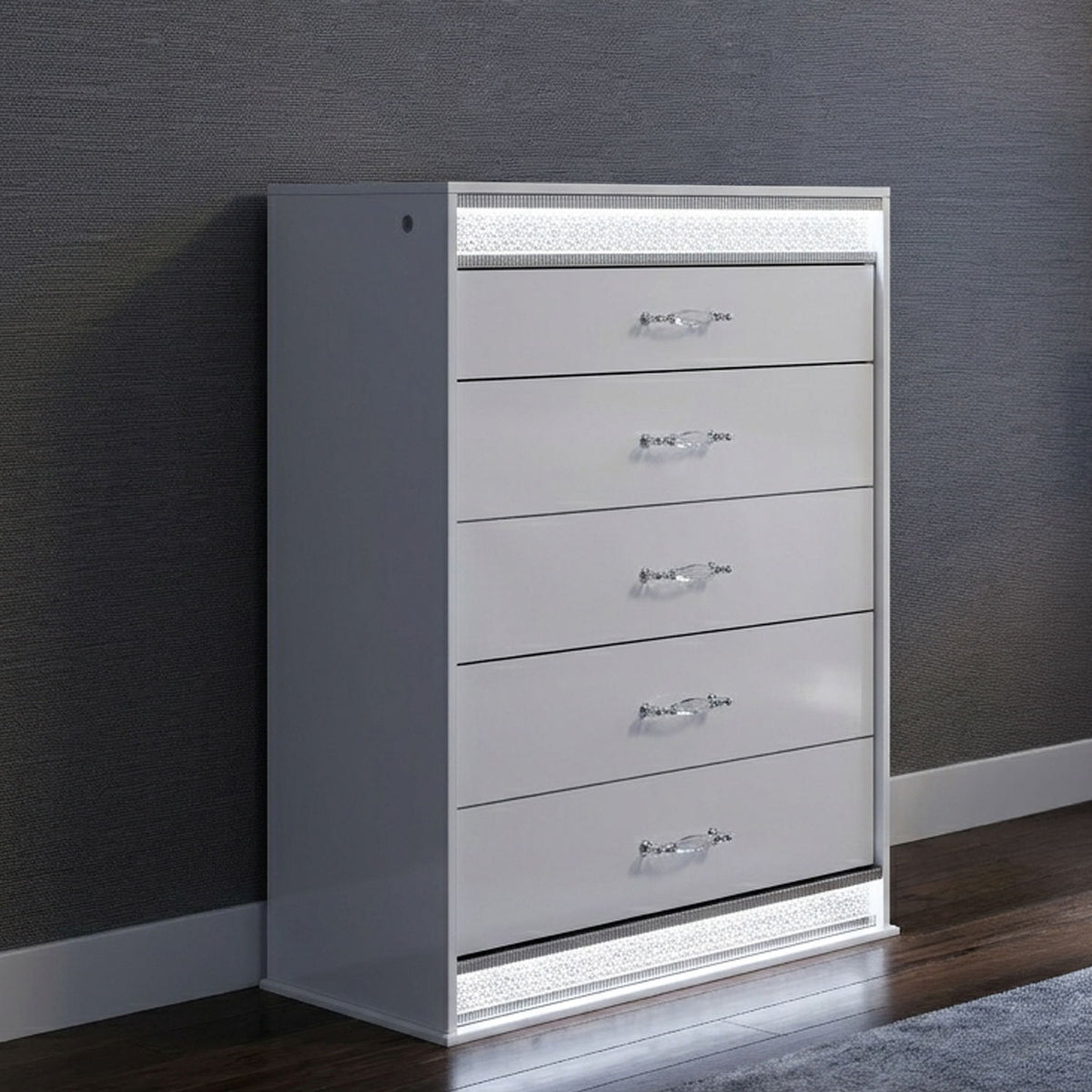 White 5-drawer chest with LED light trim, angled front view on dark wall.
