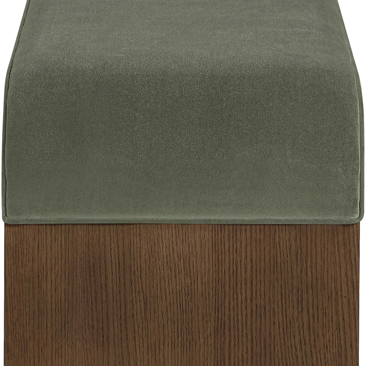 Velvet seat cushion in green on a dark wood bench base