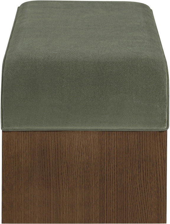 Velvet seat cushion in green on a dark wood bench base
