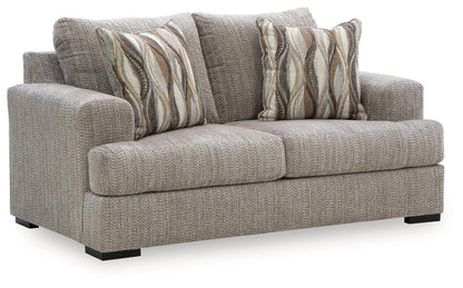 Gray textured loveseat sofa with two patterned striped throw pillows and black legs