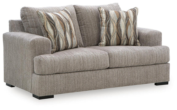 Gray textured loveseat sofa with two patterned striped throw pillows and black legs
