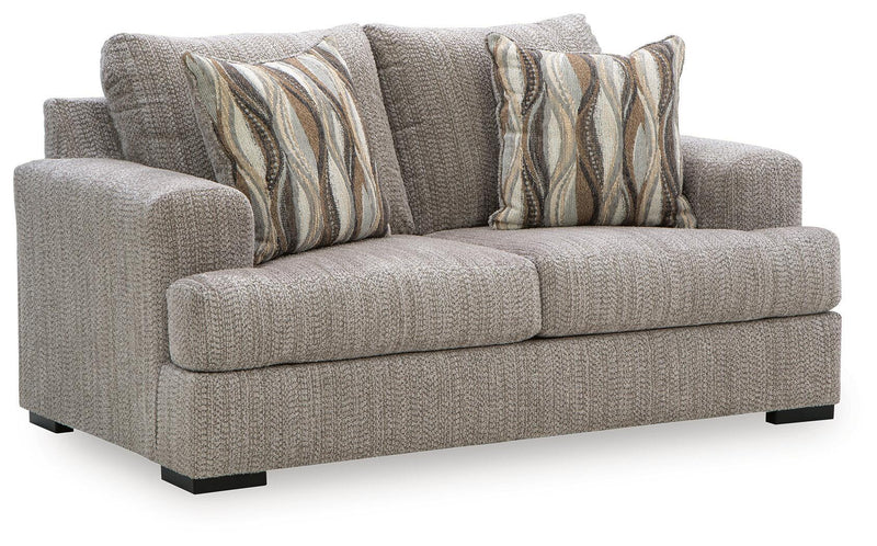 Gray textured loveseat sofa with two patterned striped throw pillows and black legs