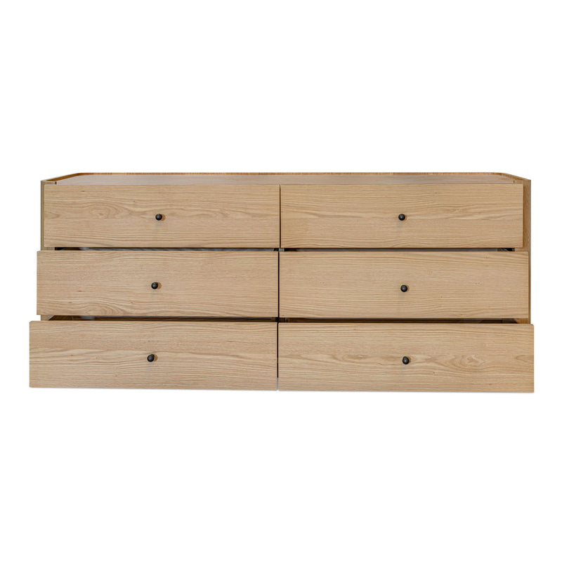 Light brown Gibson dresser with six slightly open drawers and dark knobs