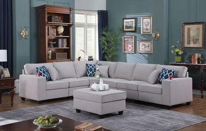 Gray sectional sofa with two ottomans and blue patterned throw pillows in a living room