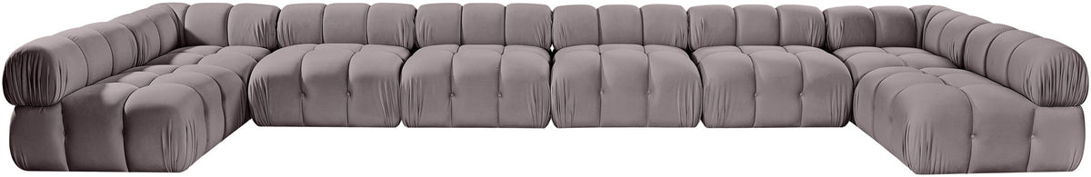 Gray modular sectional sofa with tufted cushions and curved corner design