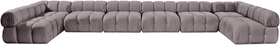 Gray modular sectional sofa with tufted cushions and curved corner design