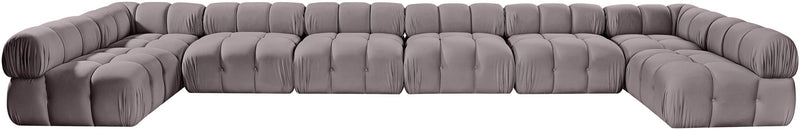 Gray modular sectional sofa with tufted cushions and curved corner design