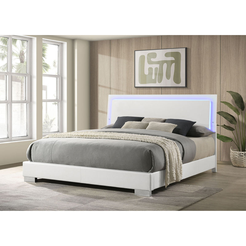 White panel bed with blue LED-lit headboard, open-frame slats, and two pillows
