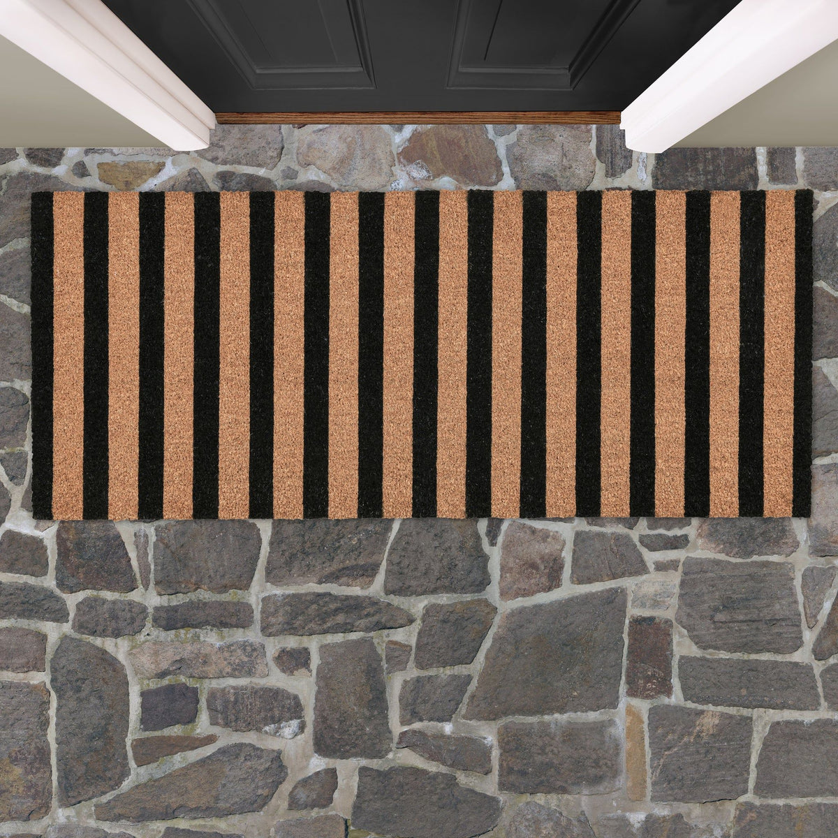 Black and natural striped doormat, shown lying flat with low-pile textured backing