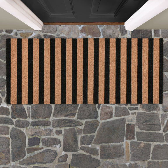 Black and natural striped doormat, shown lying flat with low-pile textured backing